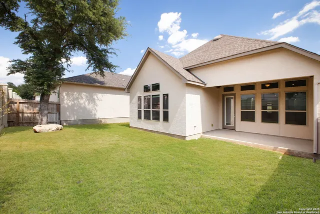 a view of a house with a yard and tree s