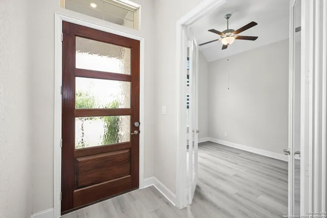 a view of an entryway with wooden floor and a window