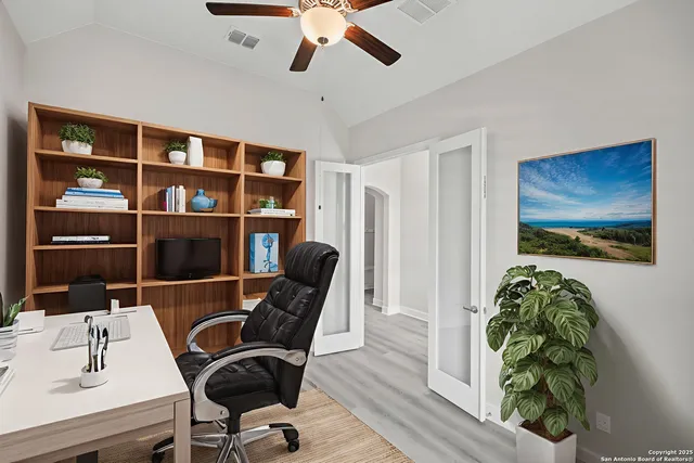 a view of a workspace with furniture and a bookshelf