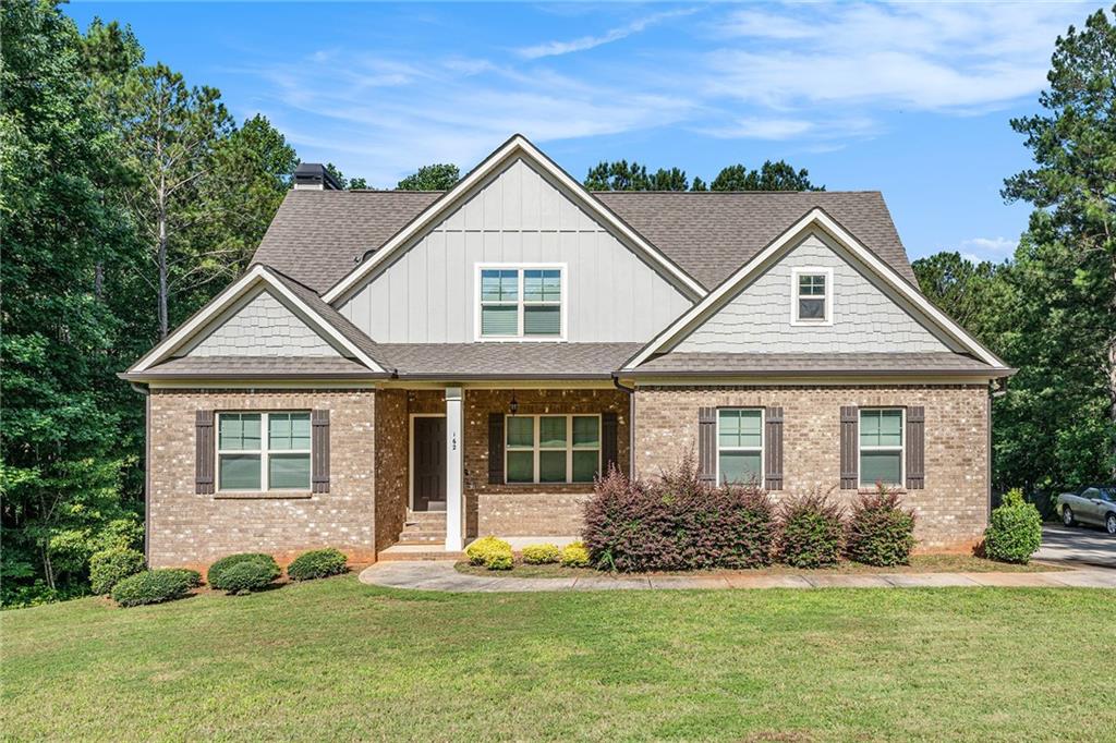 a front view of a house with a yard