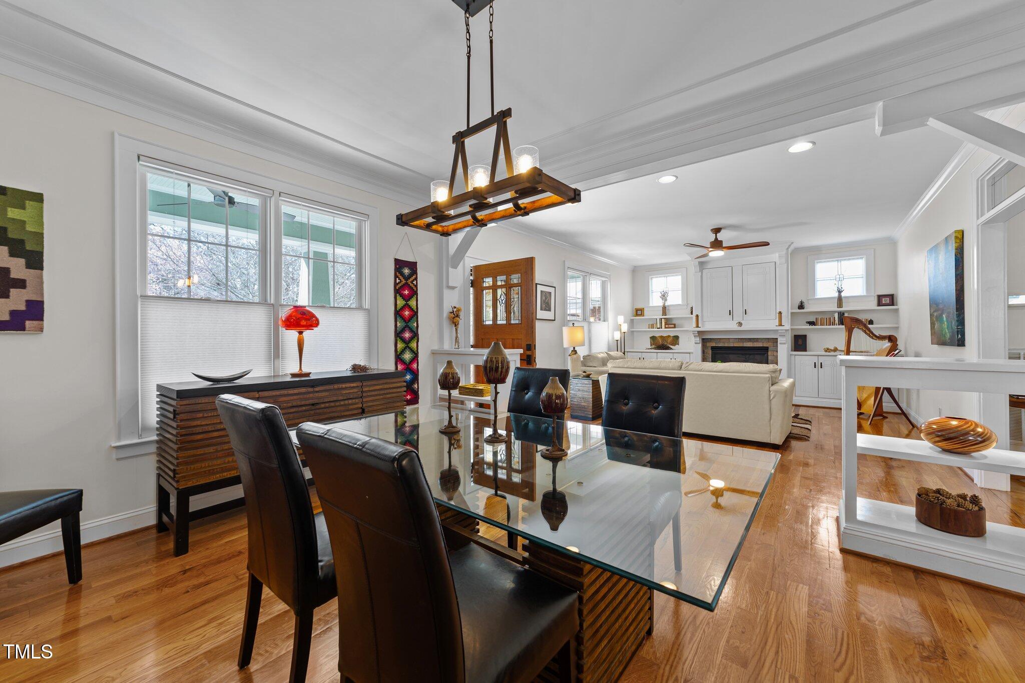 2506 Everett Avenue Raleigh, NC 27607 - Photo 9 of 45 a view of a dining room and livingroom with furniture wooden floor a chandelier
