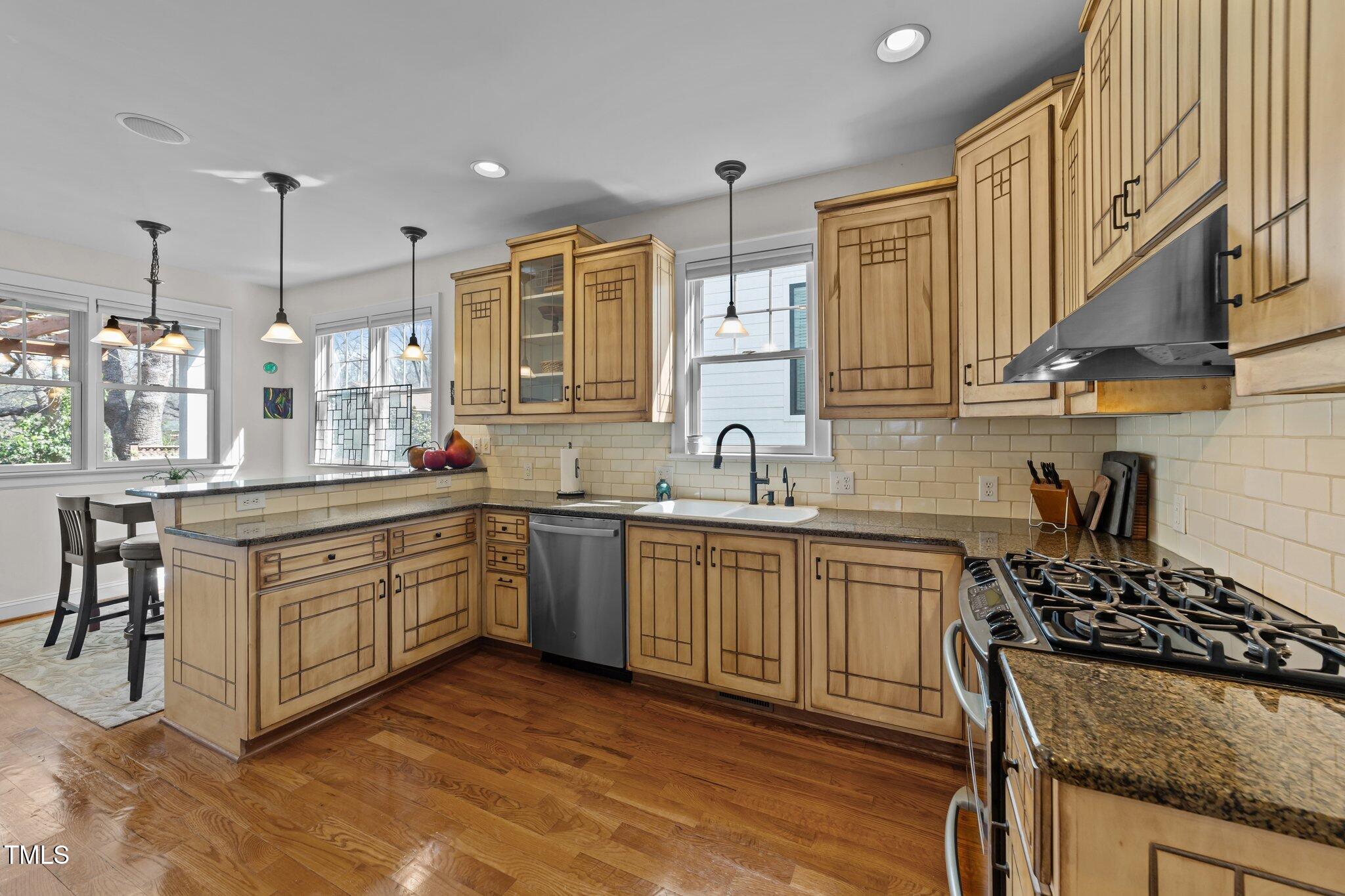 2506 Everett Avenue Raleigh, NC 27607 - Photo 10 of 45 a kitchen with stainless steel appliances granite countertop a sink stove and refrigerator