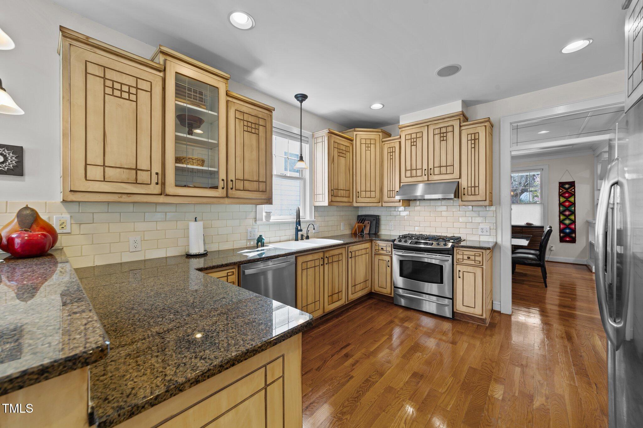 2506 Everett Avenue Raleigh, NC 27607 - Photo 11 of 45 a kitchen with stainless steel appliances granite countertop a stove a sink and a microwave