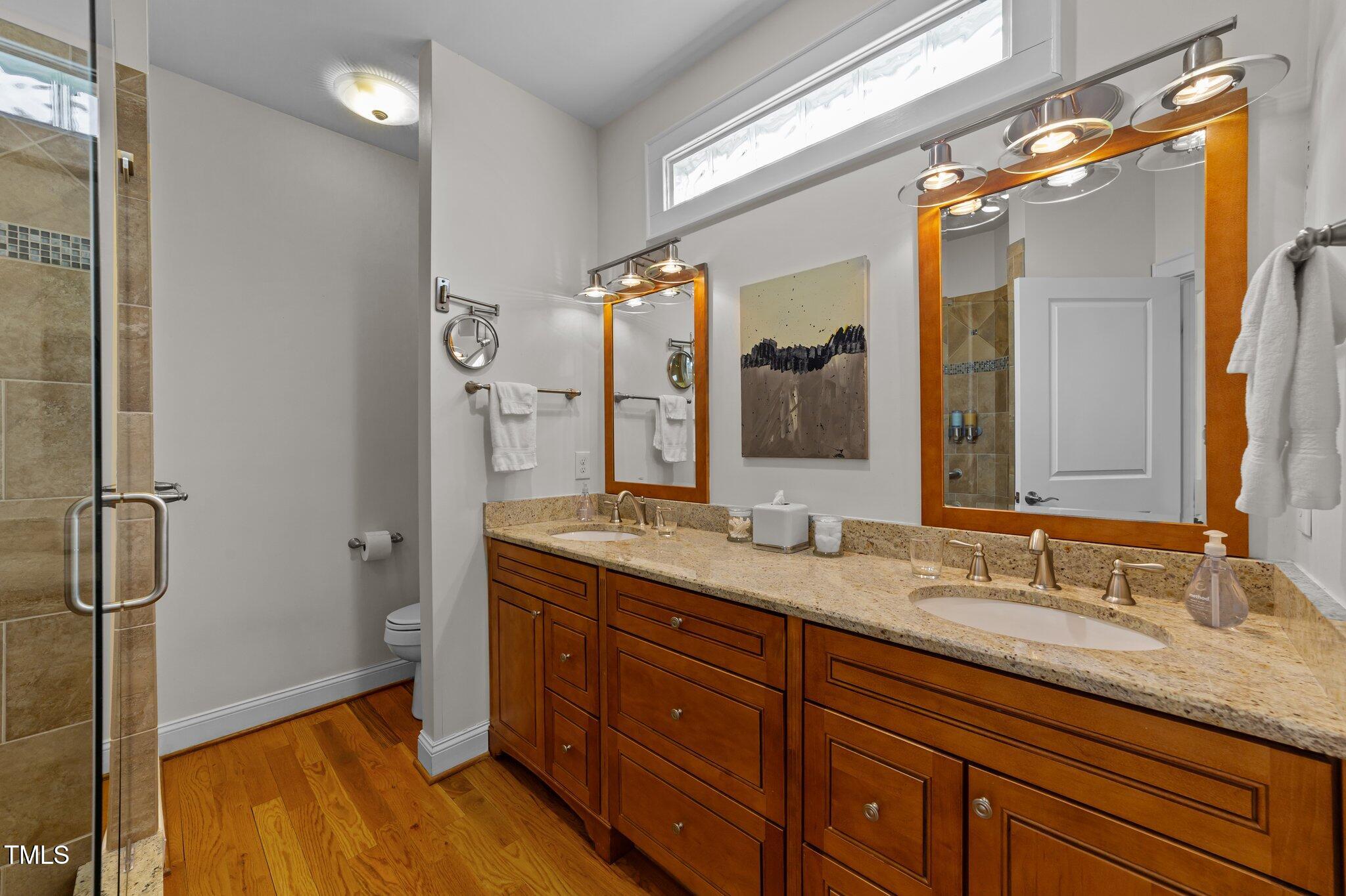 2506 Everett Avenue Raleigh, NC 27607 - Photo 17 of 45 a spacious bathroom with a granite countertop sink mirror and double