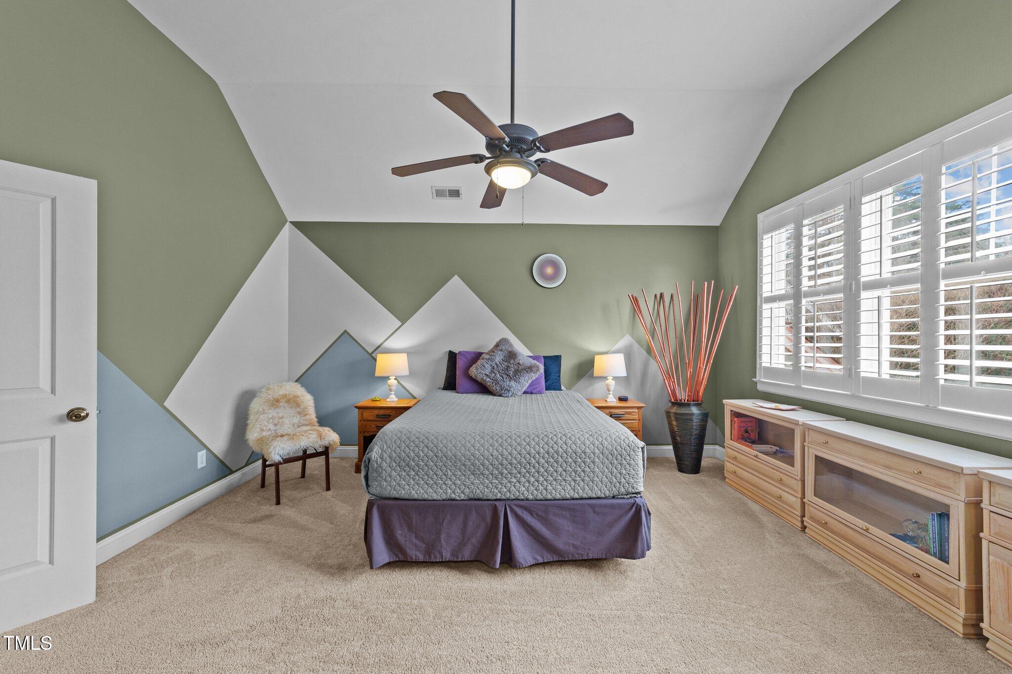 2506 Everett Avenue Raleigh, NC 27607 - Photo 21 of 45 a bedroom with a bed and a chandelier