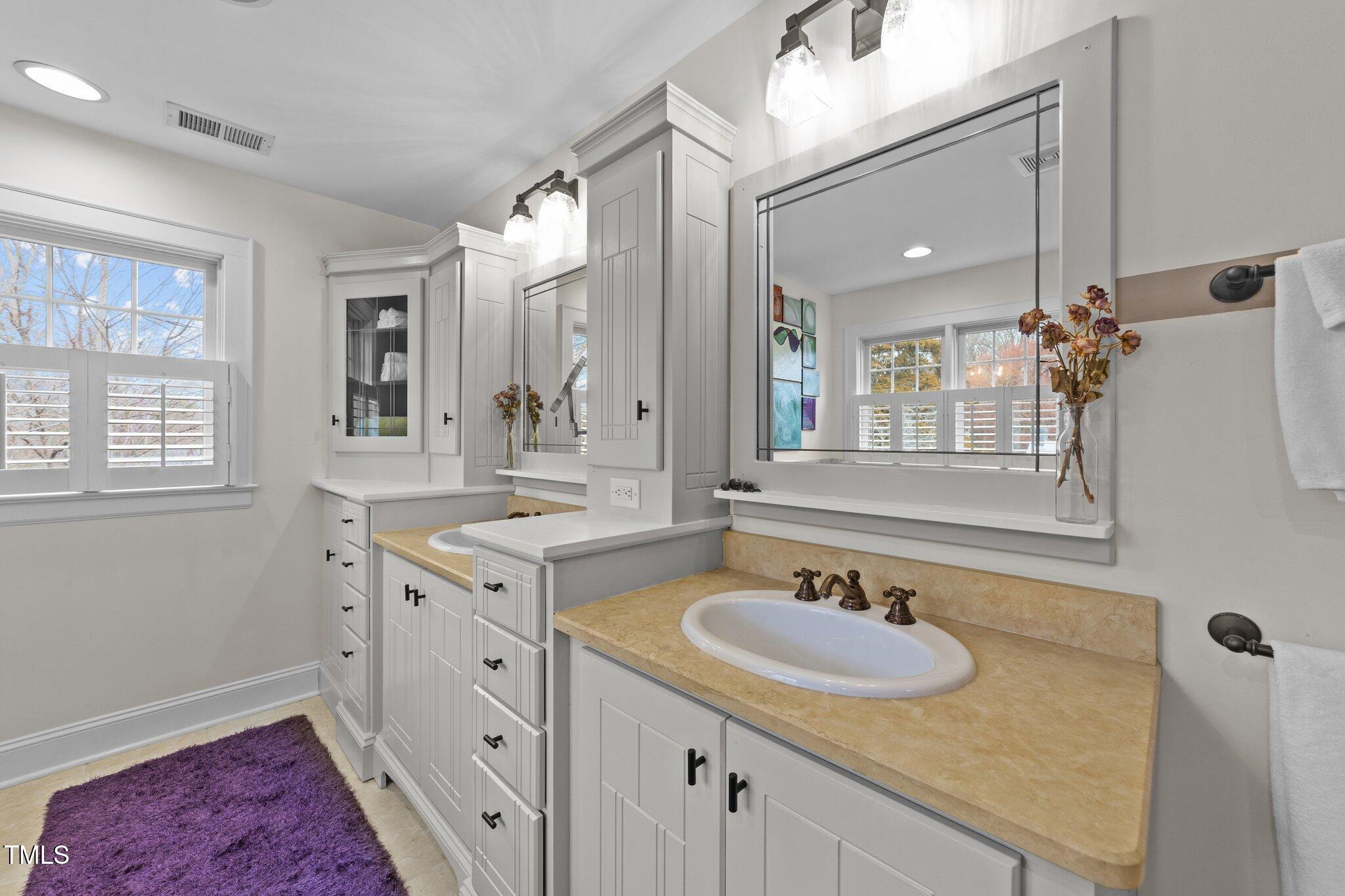 2506 Everett Avenue Raleigh, NC 27607 - Photo 27 of 45 a bathroom with a sink double vanity granite tub and a mirror