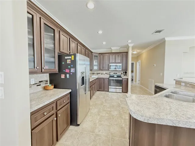 a kitchen with stainless steel appliances granite countertop a sink stove and refrigerator