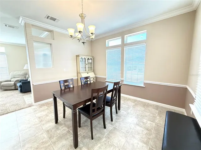 a view of a dining room with furniture and window