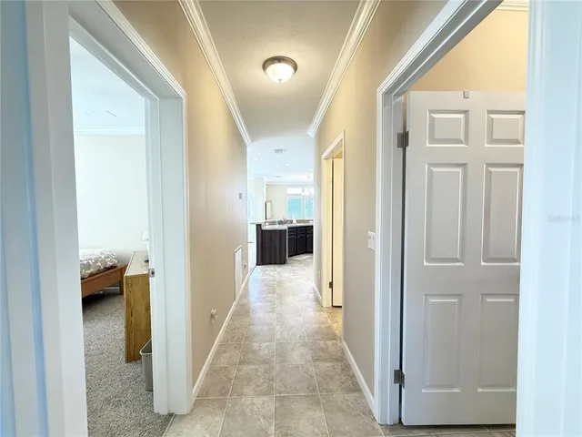 a view of a hallway with a livingroom and a livingroom with furniture