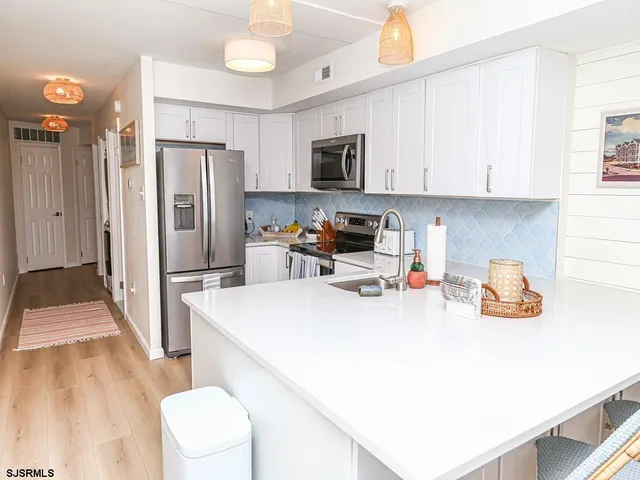a kitchen with a sink a stove and a refrigerator
