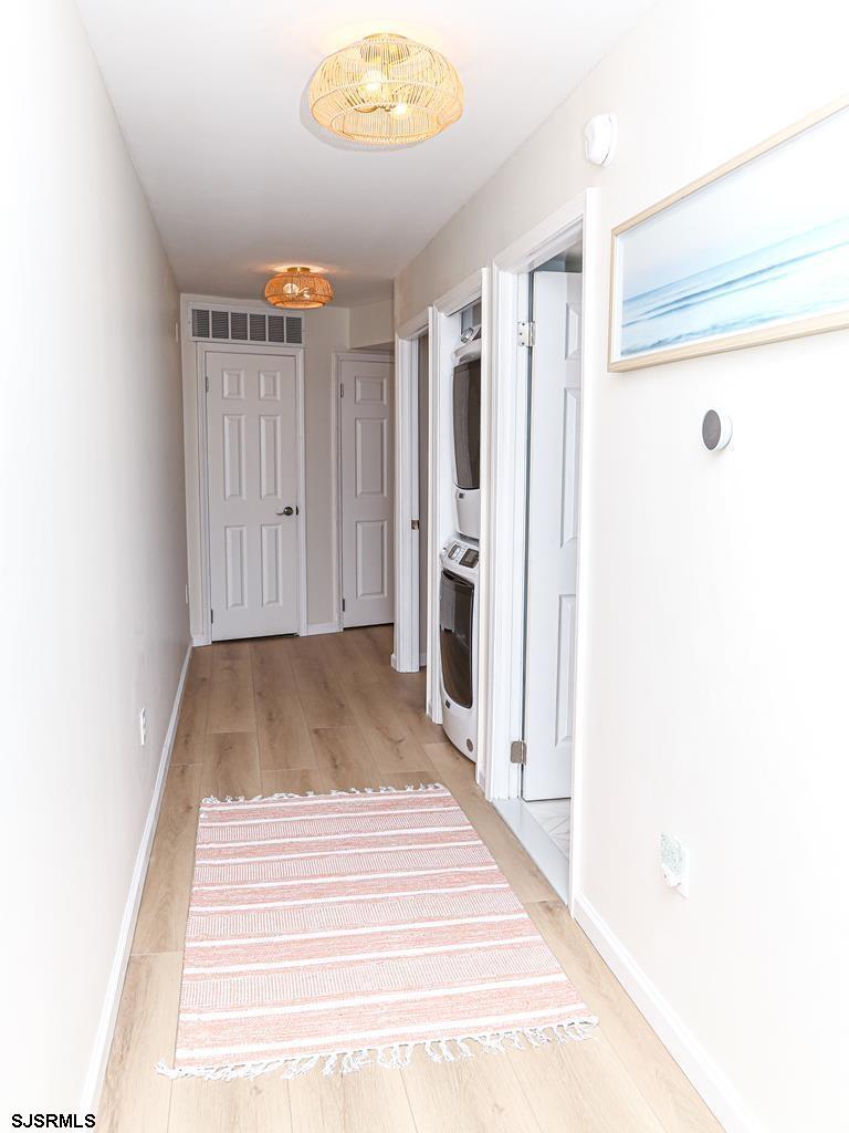 3901 Ocean Avenue, Unit 1 Brigantine, NJ 08203 - Photo 12 of 30 a view of a hallway with wooden floor and staircase