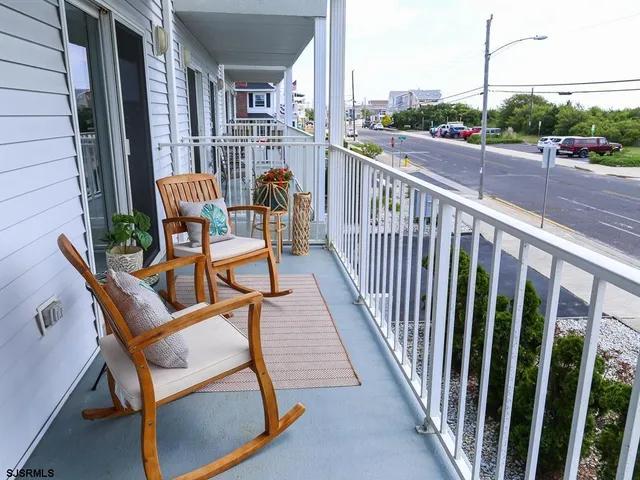 a view of a chair and tables in the balcony
