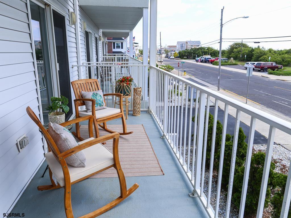 3901 Ocean Avenue, Unit 1 Brigantine, NJ 08203 - Photo 14 of 30 a view of a chair and tables in the balcony