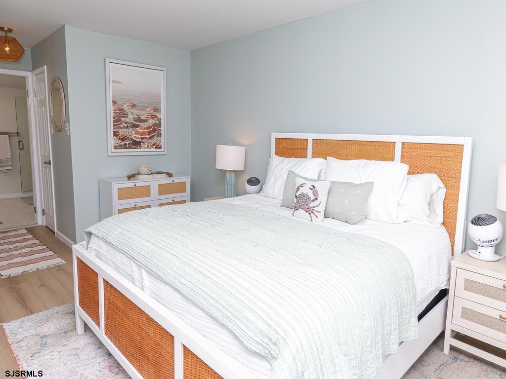 3901 Ocean Avenue, Unit 1 Brigantine, NJ 08203 - Photo 15 of 30 a bedroom with a bed and a lamp on dresser