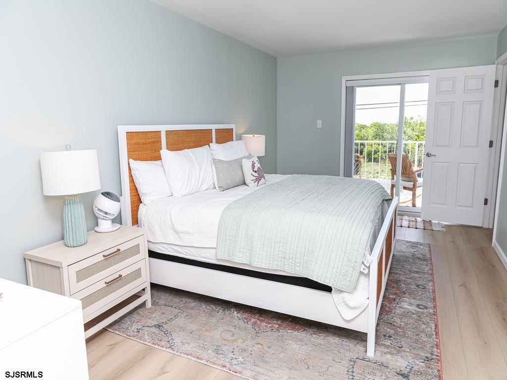 3901 Ocean Avenue, Unit 1 Brigantine, NJ 08203 - Photo 16 of 30 a bedroom with a bed lamp on table and a window