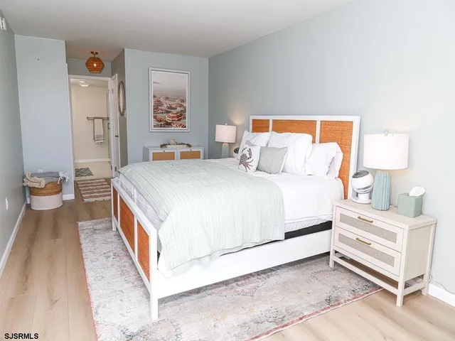 a bedroom with a bed and painting on the wall