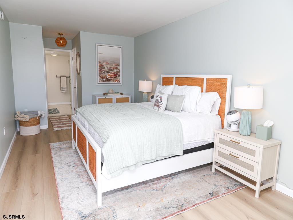 3901 Ocean Avenue, Unit 1 Brigantine, NJ 08203 - Photo 17 of 30 a bedroom with a bed and painting on the wall
