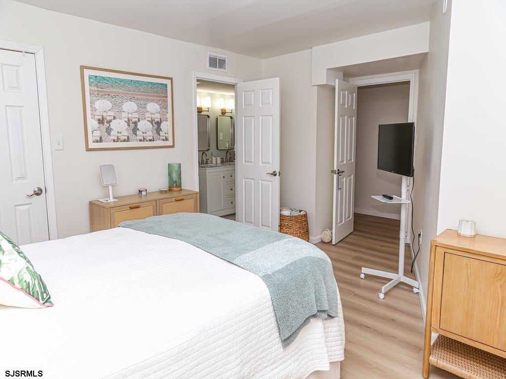 3901 Ocean Avenue, Unit 1 Brigantine, NJ 08203 - Photo 24 of 30 a bedroom with a bed and a view of bathroom