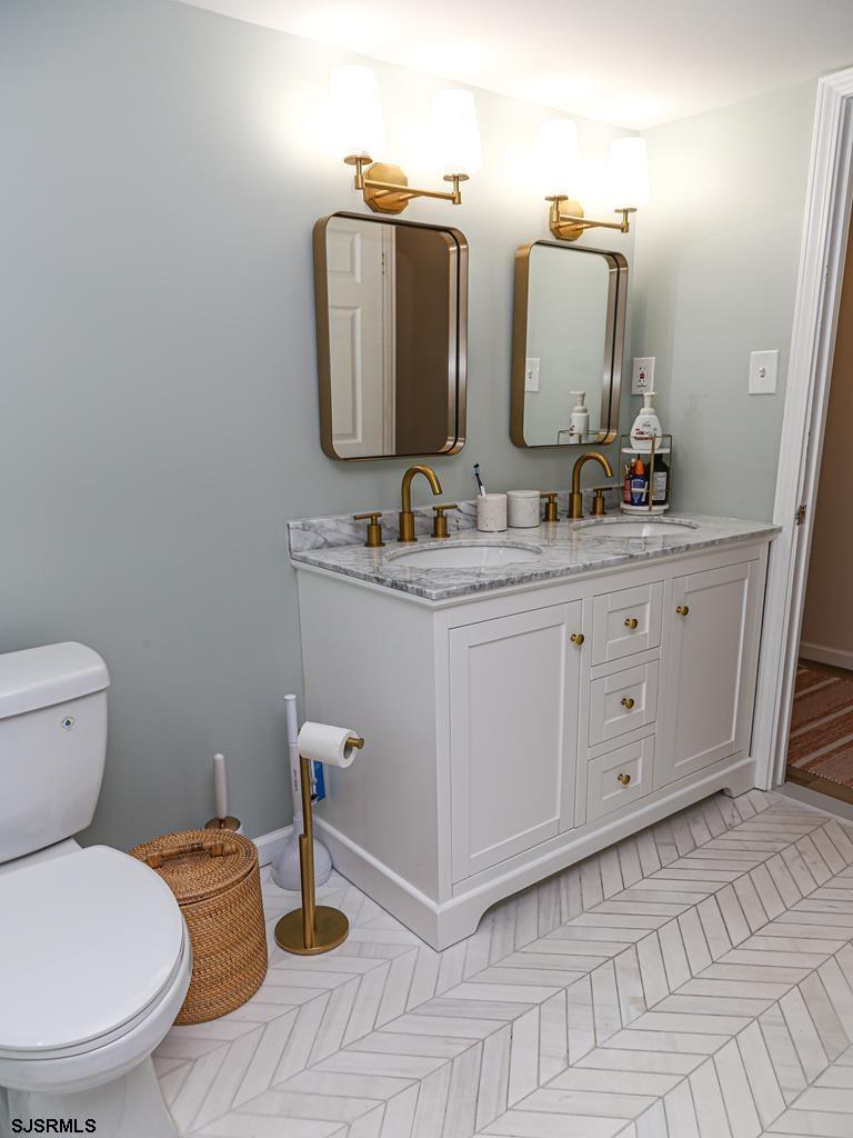 3901 Ocean Avenue, Unit 1 Brigantine, NJ 08203 - Photo 26 of 30 a bathroom with a toilet a sink and mirror