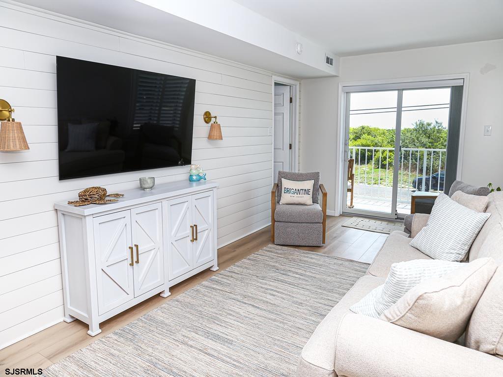 3901 Ocean Avenue, Unit 1 Brigantine, NJ 08203 - Photo 6 of 30 a living room with furniture and a flat screen tv