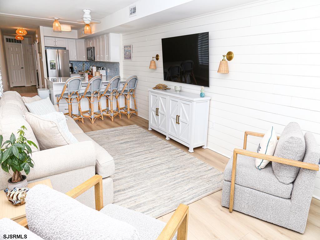 3901 Ocean Avenue, Unit 1 Brigantine, NJ 08203 - Photo 7 of 30 a living room with furniture and a flat screen tv