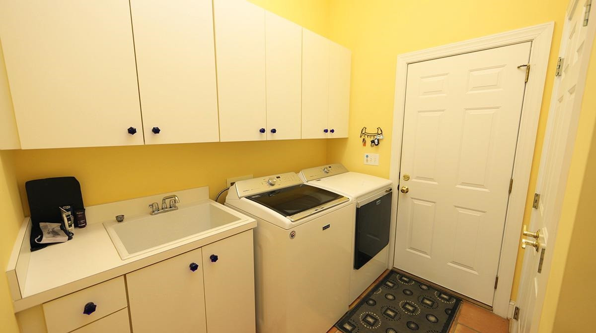 5817 Stone Spring Road Raleigh, NC 27613 - Photo 21 of 28 Convenient Laundry right off Kitchen and Garage. Offers Cabinets, Tile Flooring and Electric Dryer Hook Up. Laundry Room