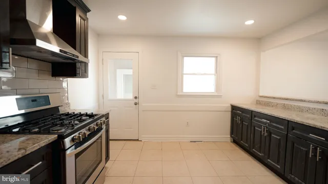 a view of a small space with wooden floor and a window