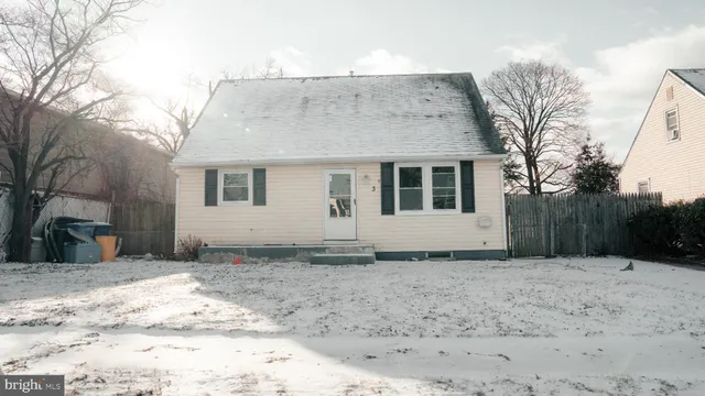 a view of an empty room with wooden floor and a ceiling fan