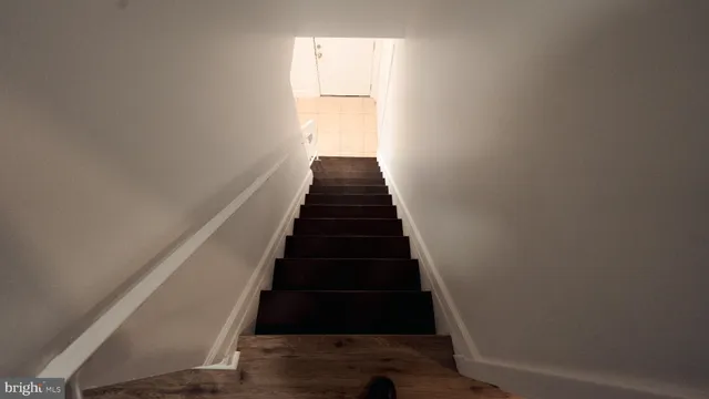 an empty room with wooden floor & closet area