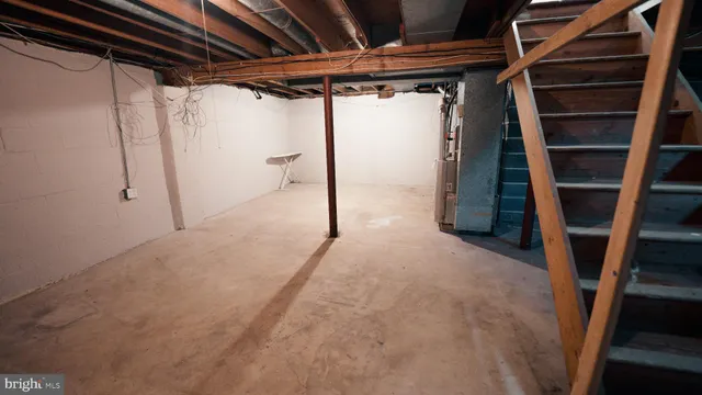 a view of a small space with wooden floor and a window