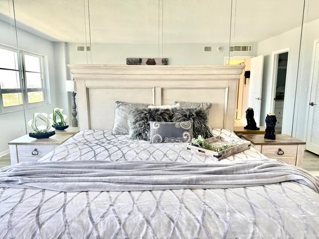 a bedroom with a bed and a chandelier