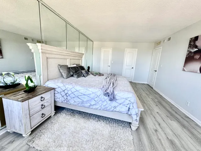 a bedroom with a bed dresser and a window