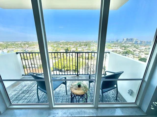 a view of living room with furniture and floor to ceiling window