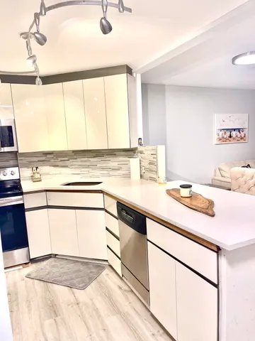 a kitchen with a sink cabinets and appliances