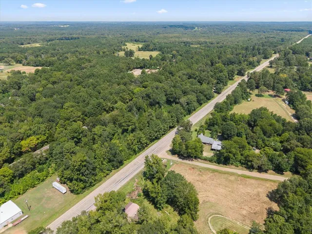 a view of a green field with an outdoor space