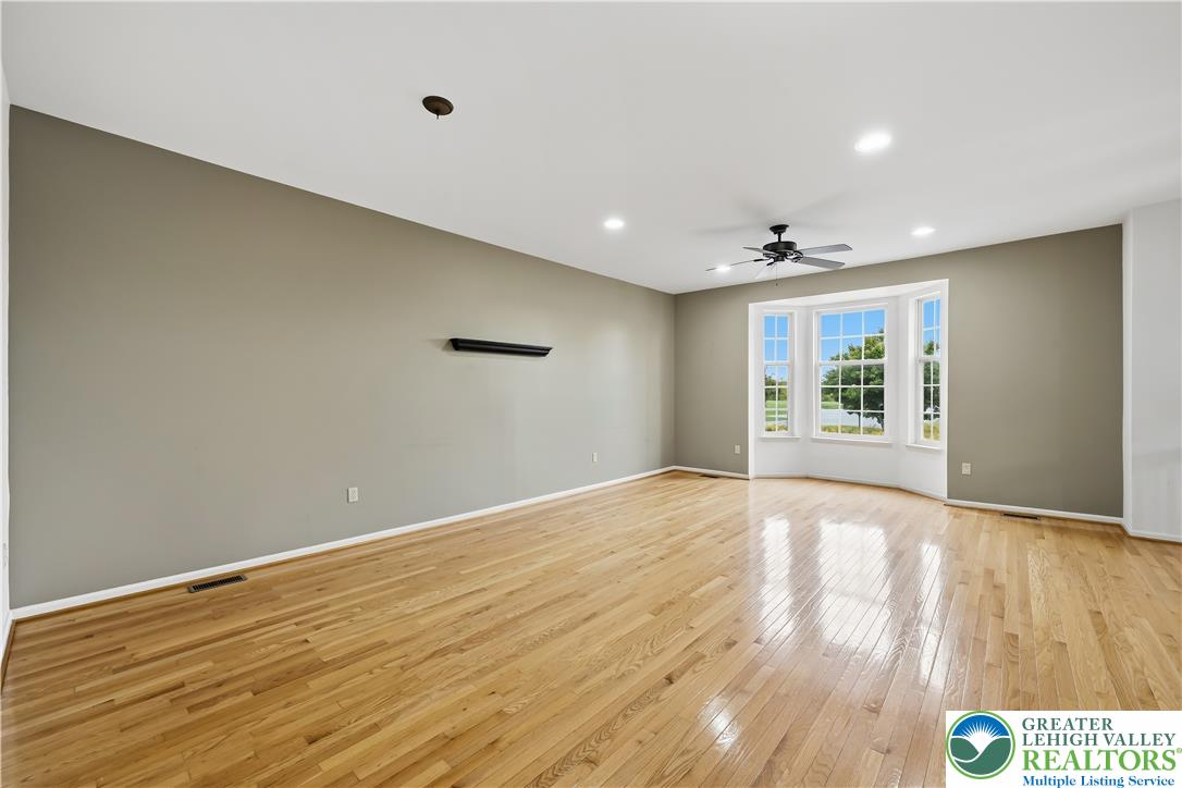 5607 Spring Ridge Drive West Macungie, PA 18062 - Photo 7 of 26 Gleaming hardwood floors and a bright bay window anchor this versatile living space.