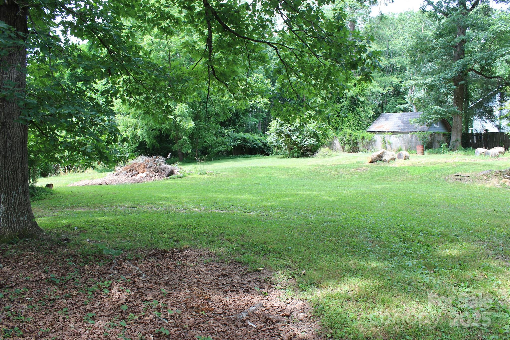 158 School House Road Mills River, NC 28759 - Photo 5 of 22 a backyard of a house with plants and large trees