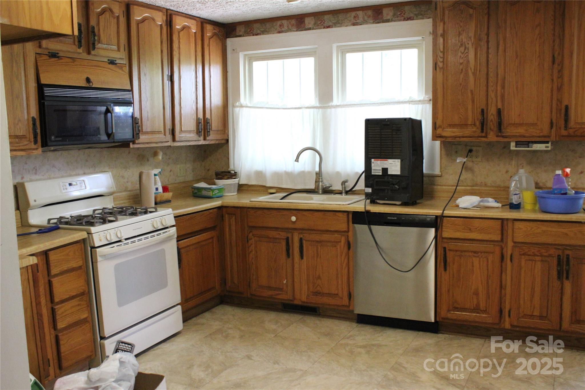 158 School House Road Mills River, NC 28759 - Photo 10 of 22 a kitchen with stainless steel appliances granite countertop a stove a sink dishwasher and a microwave