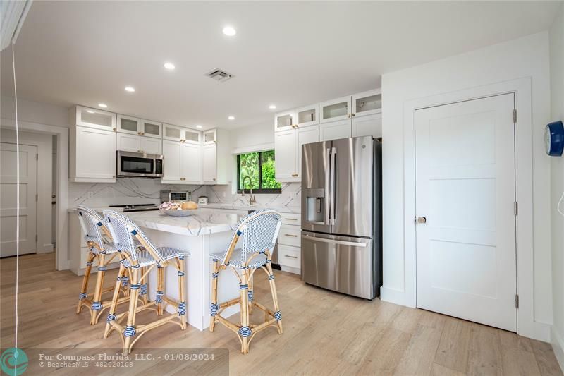 2375 Northeast 29th Street Lighthouse Point, FL 33064 - Photo 19 of 76 a kitchen with stainless steel appliances a refrigerator stove microwave and cabinets