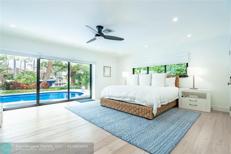 2375 Northeast 29th Street Lighthouse Point, FL 33064 - Photo 24 of 76 a bedroom with a large bed and a large window