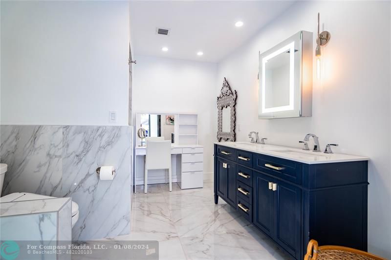 2375 Northeast 29th Street Lighthouse Point, FL 33064 - Photo 26 of 76 a spacious bathroom with a double vanity sink a mirror and a toilet
