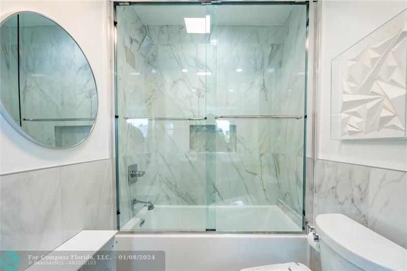 2375 Northeast 29th Street Lighthouse Point, FL 33064 - Photo 33 of 76 a bathroom with a bathtub and a shower