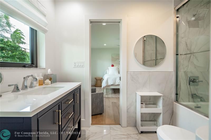 2375 Northeast 29th Street Lighthouse Point, FL 33064 - Photo 35 of 76 a bathroom with a sink a toilet and shower