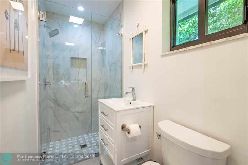 2375 Northeast 29th Street Lighthouse Point, FL 33064 - Photo 39 of 76 a bathroom with a sink a toilet and shower