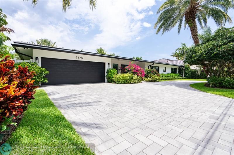 2375 Northeast 29th Street Lighthouse Point, FL 33064 - Photo 4 of 76 a front view of house with yard and green space