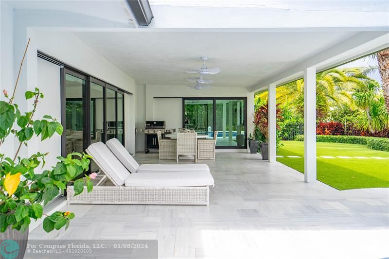 2375 Northeast 29th Street Lighthouse Point, FL 33064 - Photo 50 of 76 a living room with a floor to ceiling window and yard