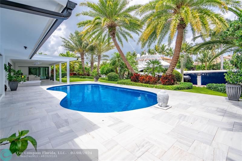 2375 Northeast 29th Street Lighthouse Point, FL 33064 - Photo 51 of 76 a view of a swimming pool with a garden