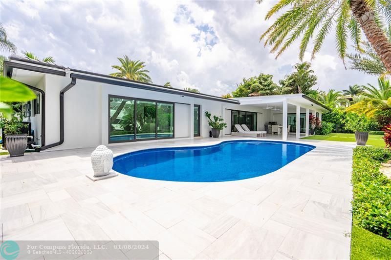2375 Northeast 29th Street Lighthouse Point, FL 33064 - Photo 52 of 76 a view of a swimming pool with a patio