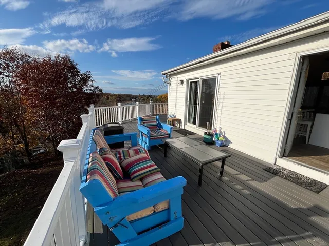 a view of a roof deck with wooden floor and city view