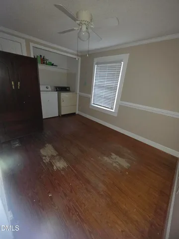 a view of a room with wooden floor closet and windows